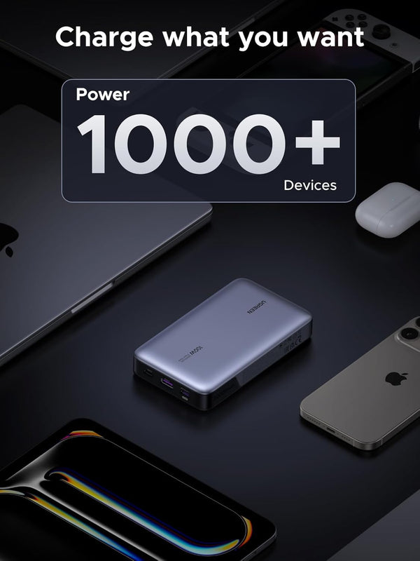 Portable power bank with devices on a dark surface, emphasizing its ability to charge multiple devices.